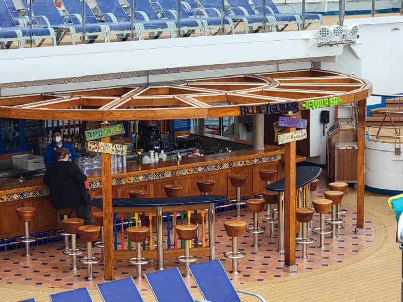 Blue Iguana tequila bar with people sitting on stools near the bar