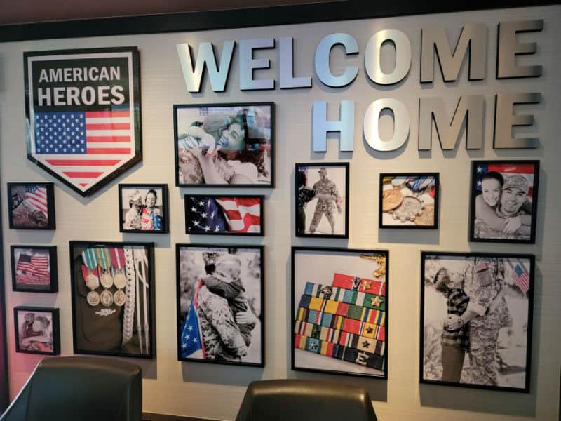 American Heroes welcome home sign over military photos