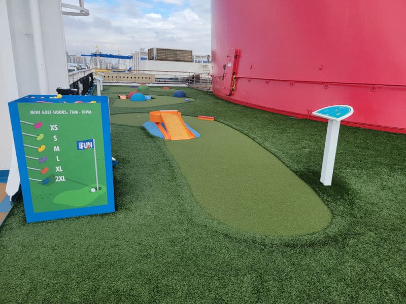 mini golf with clubs and a putting green 
