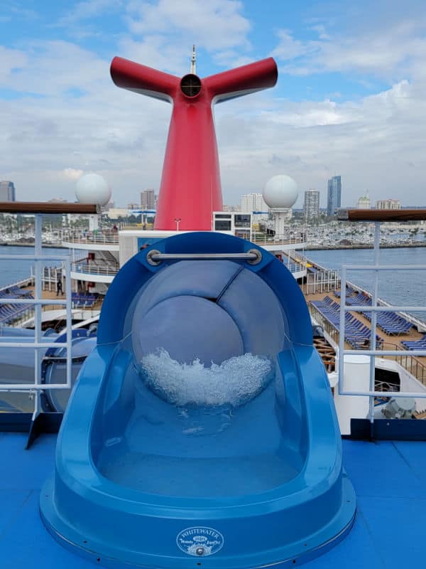 waterslide entrance with Carnival cruise funnel in the background