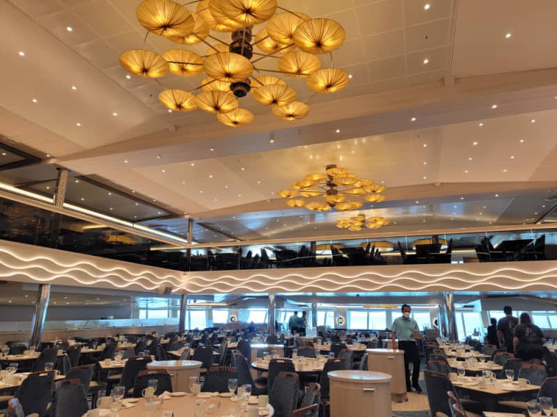 Chandeliers over a large dining room with servers