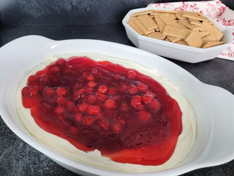Cherry Cheesecake dip in a large white bowl with graham crackers