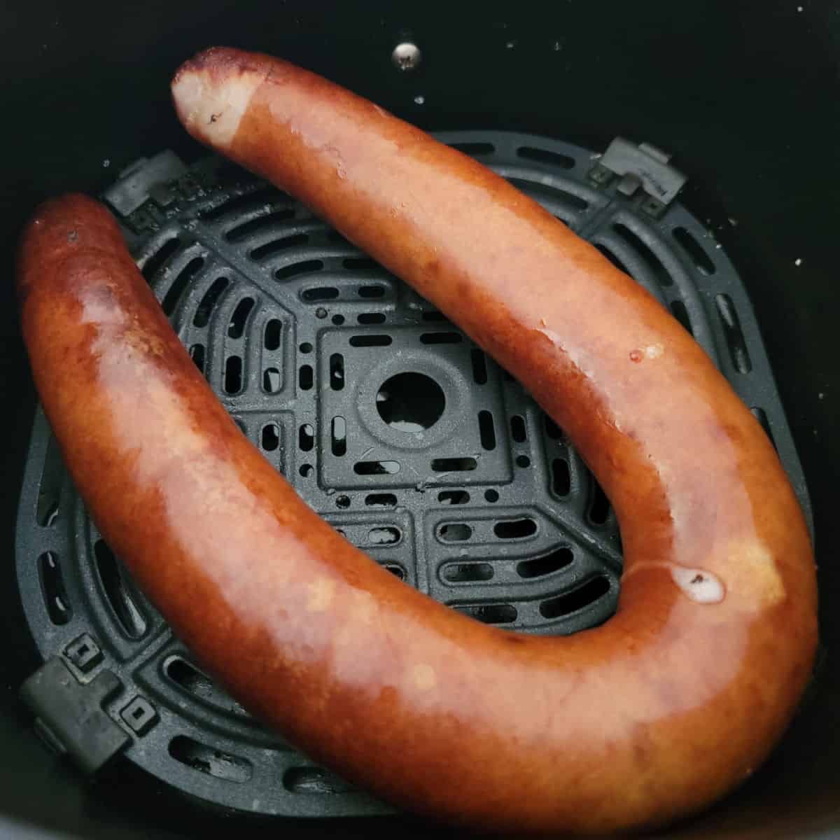 Air fried kielbasa in an air fryer basket