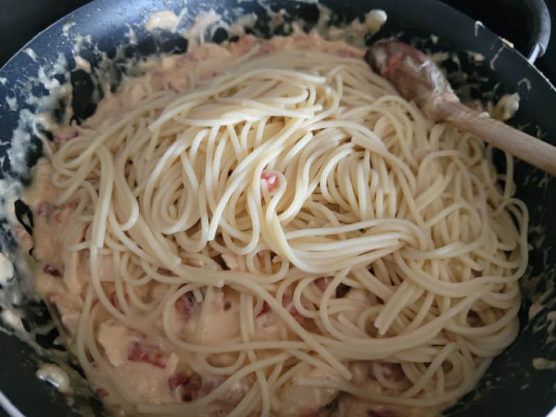 Spaghetti noodles in a pan with creamy chicken for Rotel Chicken Spaghetti