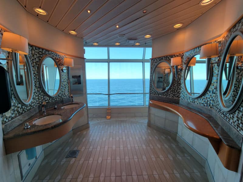 bathroom mirrors and sinks with a view of the ocean 