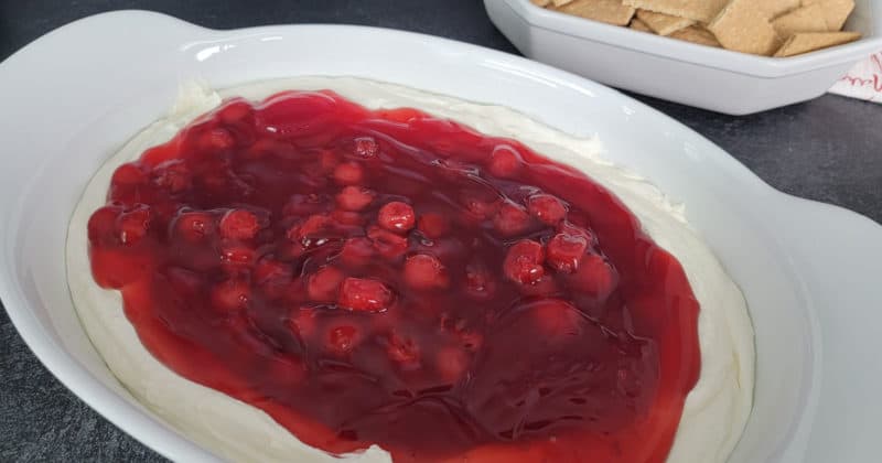 No Bake Cherry cheese cake dip in a white serving bowl with graham crackers