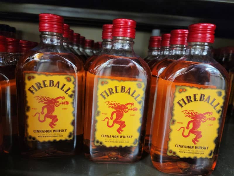 Fireball bottles lined up on a shelf. 