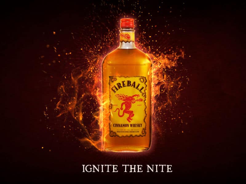 Ignite the Nite printed below a bottle of Fireball with flames