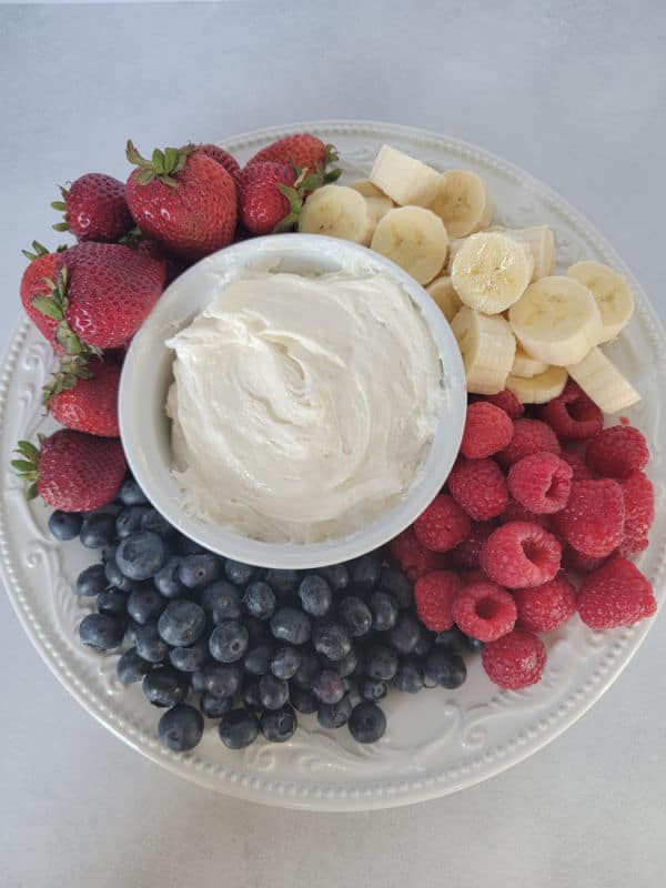 3 Ingredient Marshmallow fluff fruit dip in a white bowl surrounded by fresh fruit