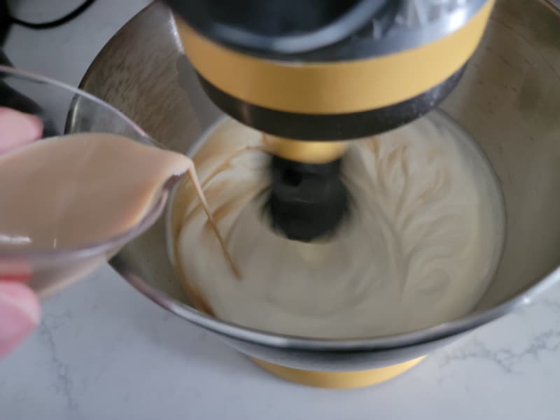 Bailey's pouring into a mixing bowl while it spins