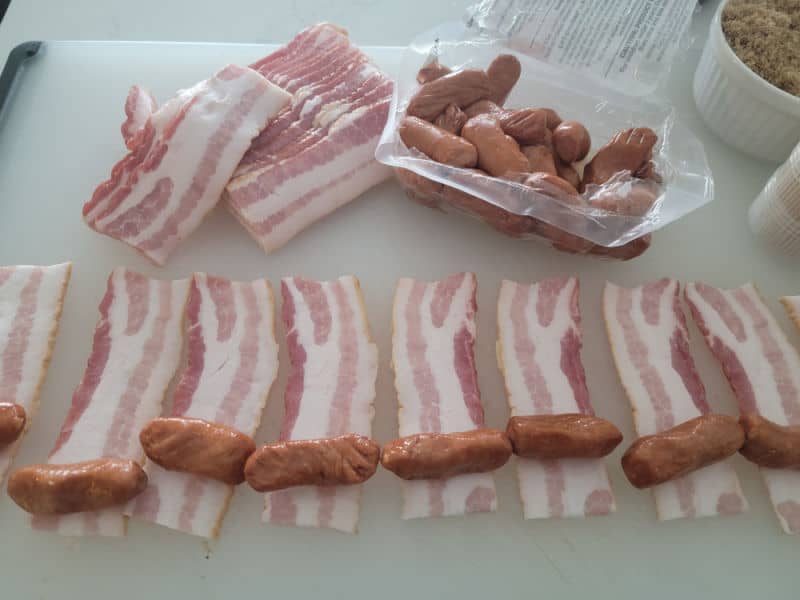 Cut bacon slices with lit'l smokies at the end for bacon wrapped little smokies