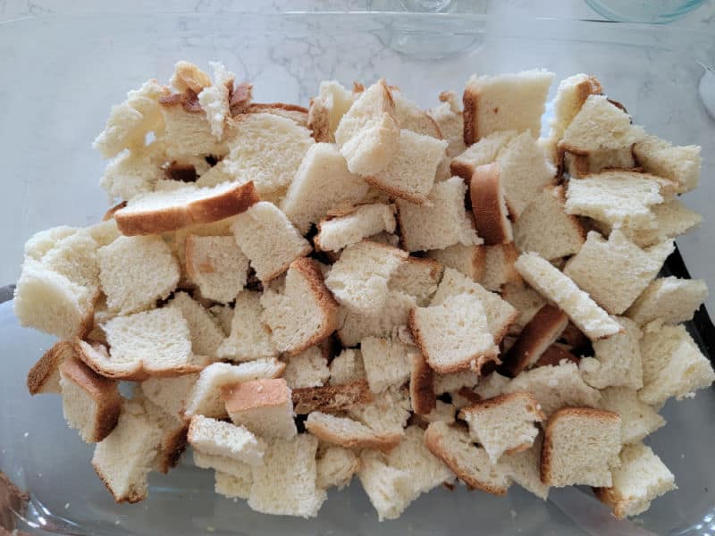 Pieces of bread in a casserole dish for Overnight French Toast Casserole