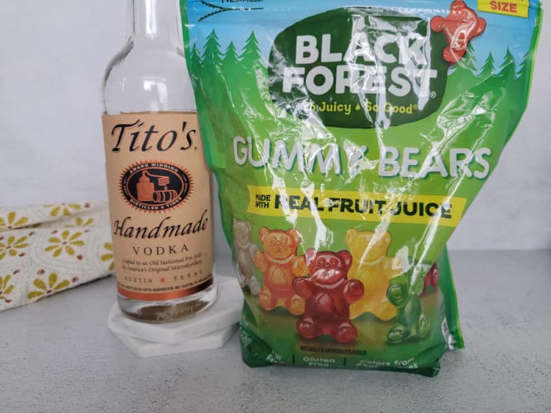 Tito's vodka bottle next to a large bag of Black Forest Gummy Bears