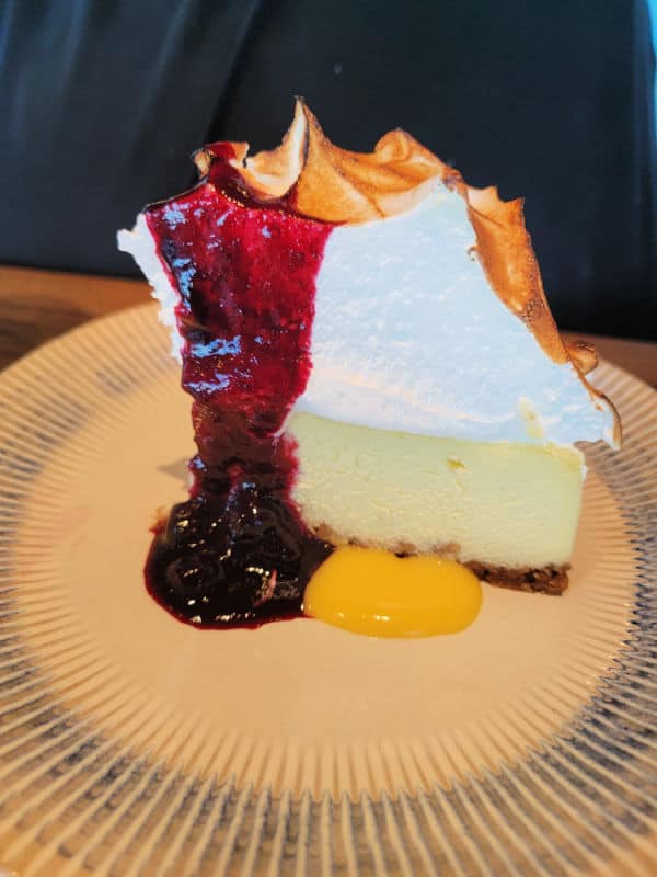 Key lime pie with meringue and a fruit sauce