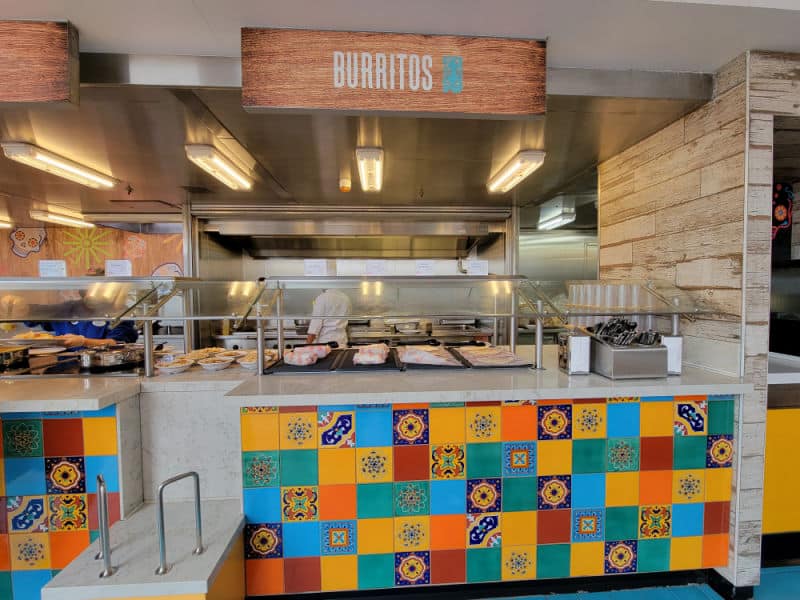 Burritos sign over a food area with colorful tiles