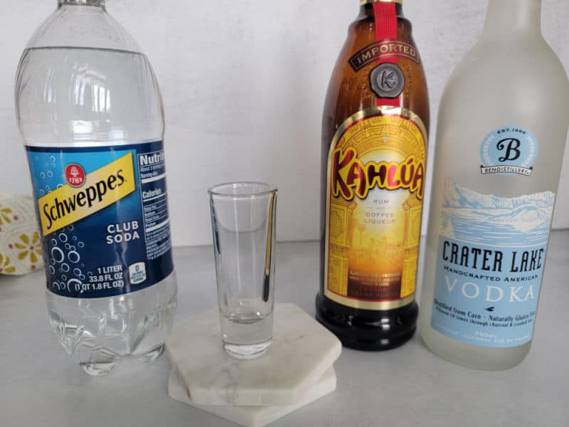 Mind Eraser Shot ingredients Club Soda, Kahlua Coffee Liqueur, and Vodka with a shot glass