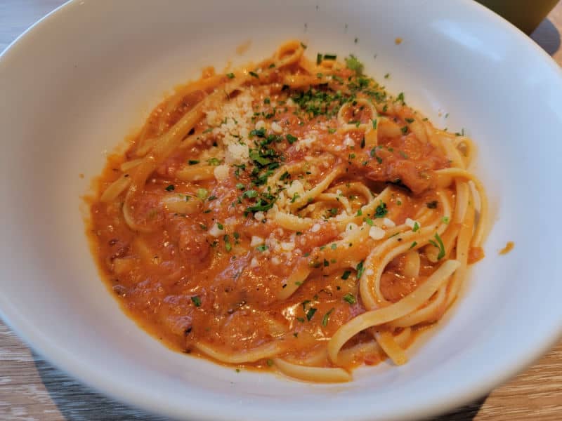Pasta with red sauce in a white bowl 
