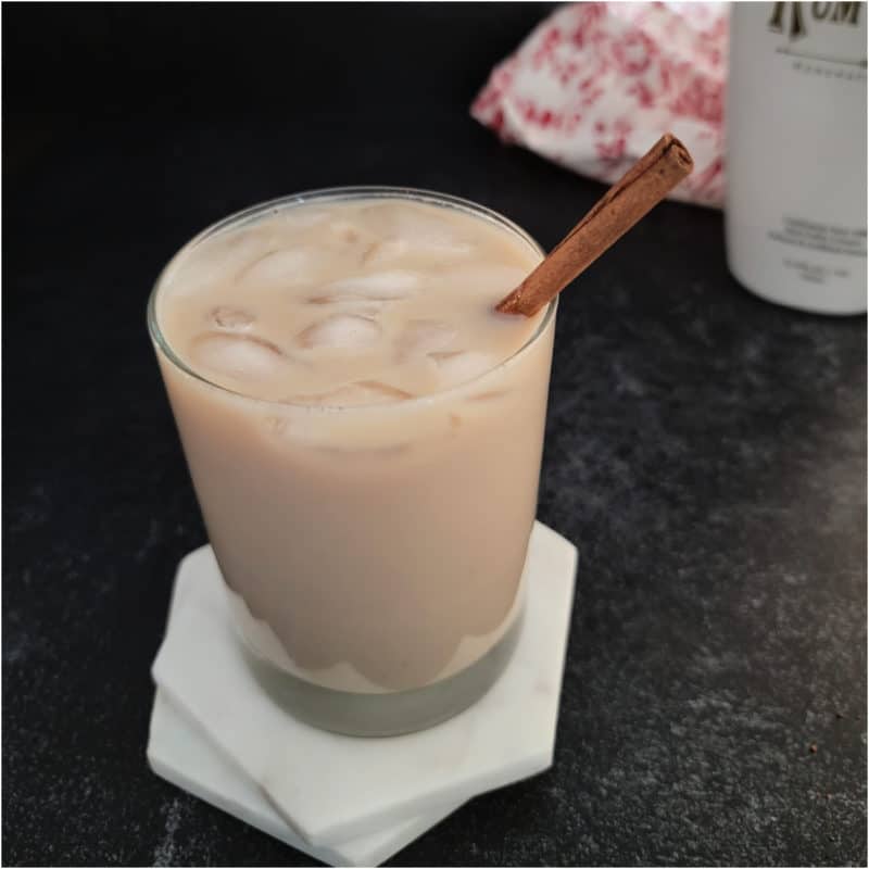 RumChata Iced Coffee with a cinnamon stick garnish on white coasters
