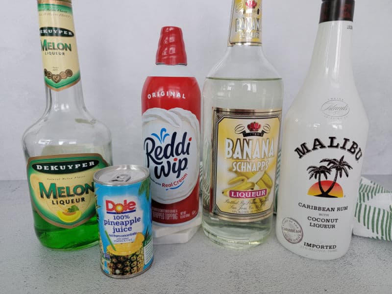 Scooby Snack Shot ingredients Melon Liqueur, Pineapple Juice, whipped cream, banana schnapps, and malibu coconut rum