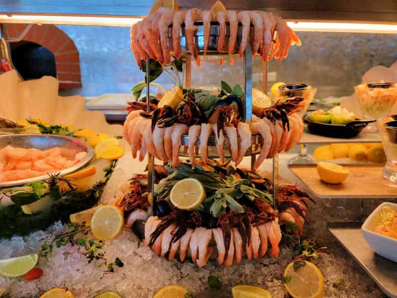 Shrimp tower surrounded by other food and ice