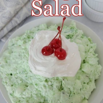 Watergate Salad text over a green jello salad with Cool Whip and a maraschino cherry