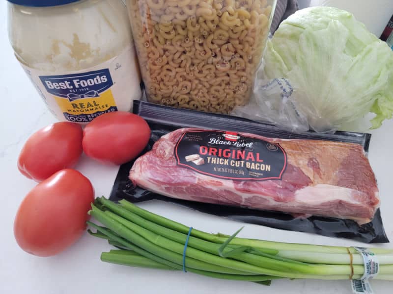 Best Foods Mayo, macaroni dry pasta, lettuce, three tomatoes, a package of bacon, and green onions 