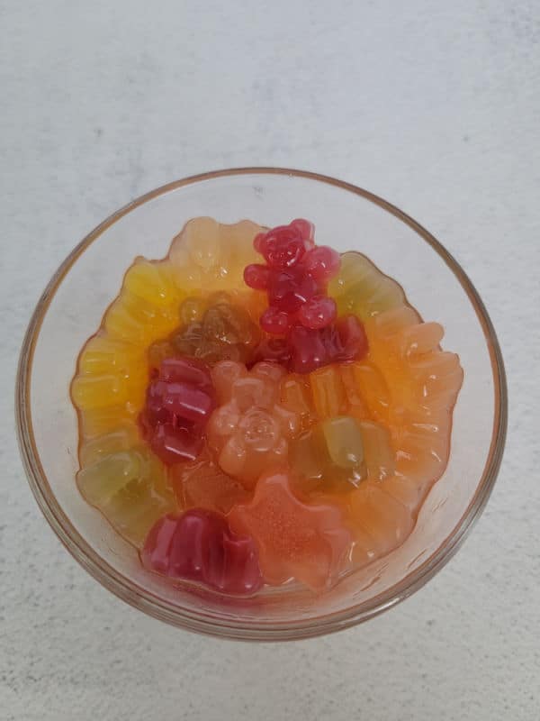puffy gummy bears in a glass bowl with liquid 