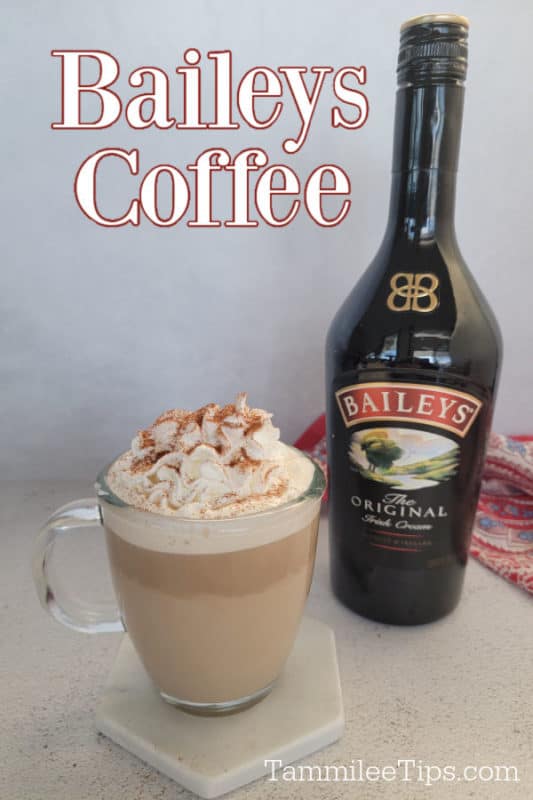 Baileys Coffee over a coffee with whipped cream garnish and a bottle of Baileys Irish Cream 