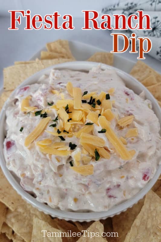 Fiesta Ranch Dip text over a white bowl with dip garnished in shredded cheddar cheese