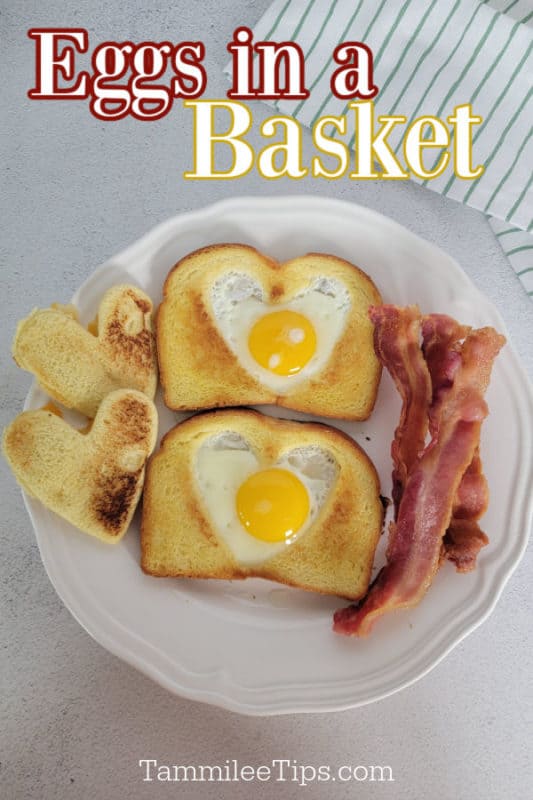 Eggs in a basket over a white plate with two pieces of eggs in a basket toast and bacon