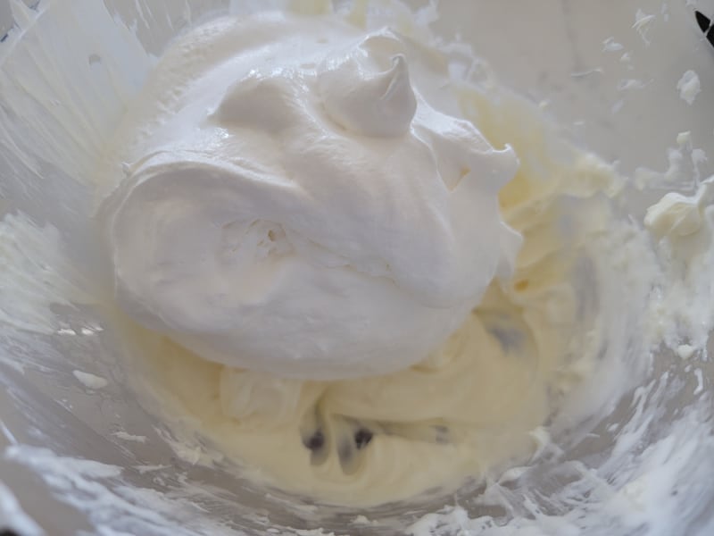 Cool whip on cream cheese mixture in a glass bowl 