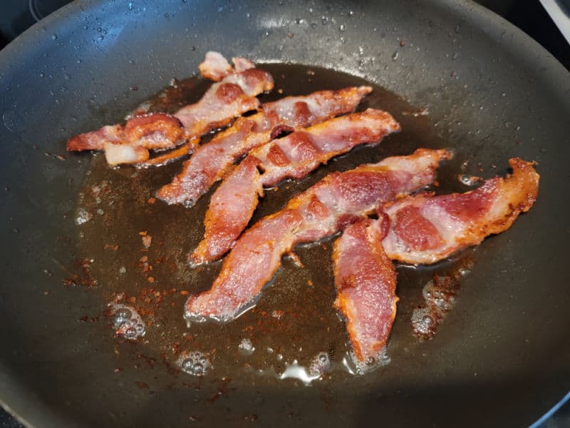 Bacon cooking in a frying pan