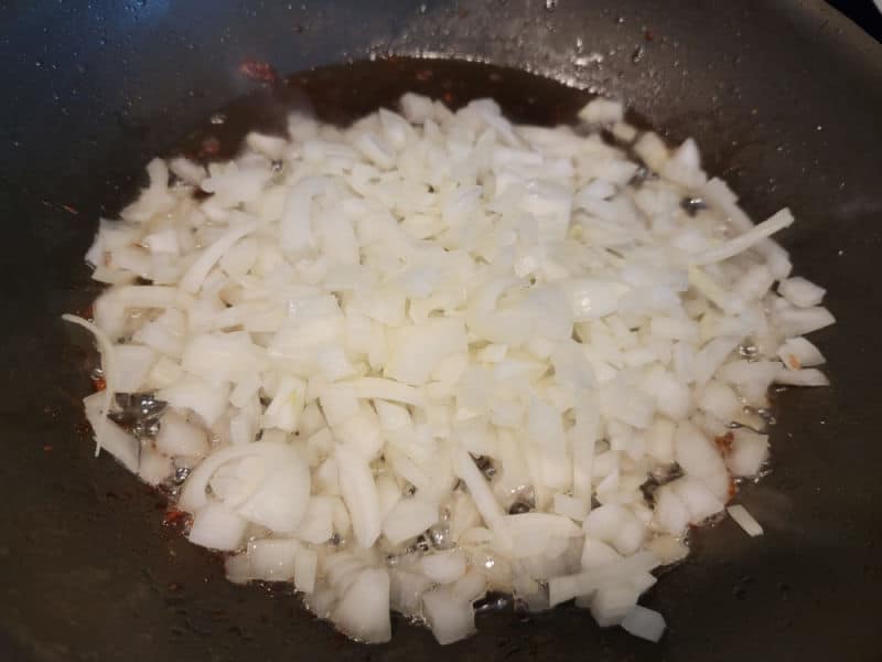 Onions in bacon grease in a frying pan