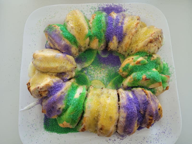 green, gold, and purple sprinkles on cinnamon rolls