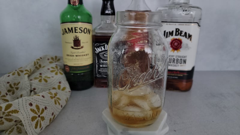 Mason jar filled with ice and liquor