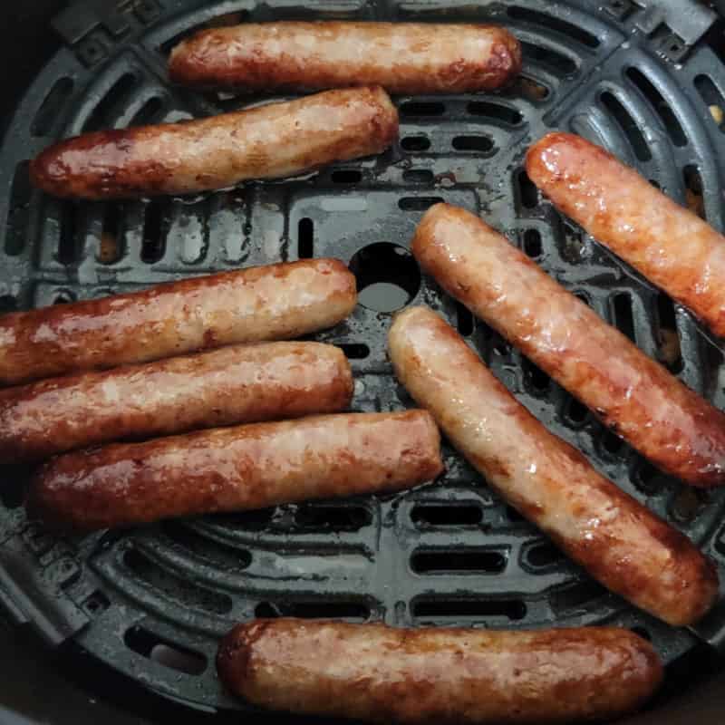 Air fried sausage links in an air fryer basket