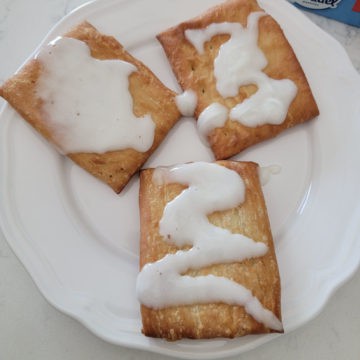 Three air fried toaster strudel on a white plate