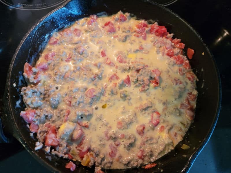 Ground beef and diced tomato dip in a cast iron skillet 