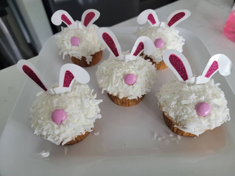 bunny cupcakes lined up on a white platter