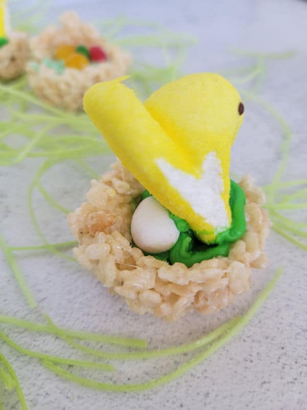 Peeps on a chocolate egg in a rice krispie nest