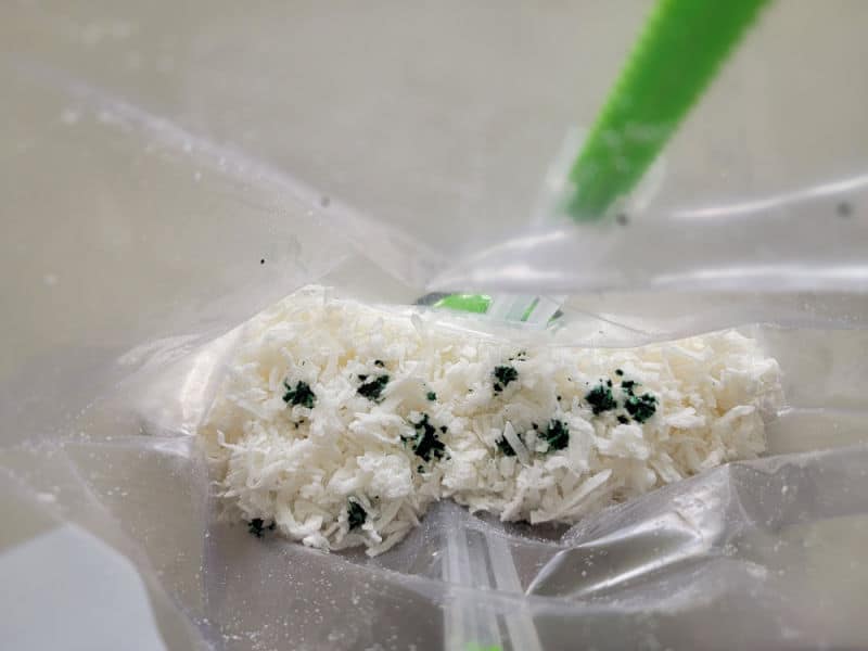 green drops on coconut in a bag