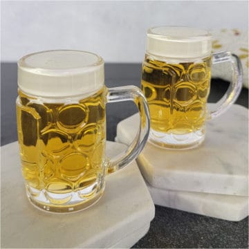 Mini beer shots in mini beer glasses on white coasters