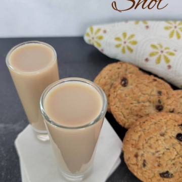 Oatmeal cookie shot text over two filled shot glasses next to oatmeal cookies