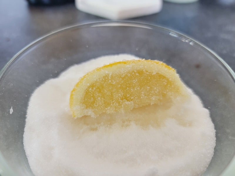 Lemon slice covered in sugar in a glass bowl
