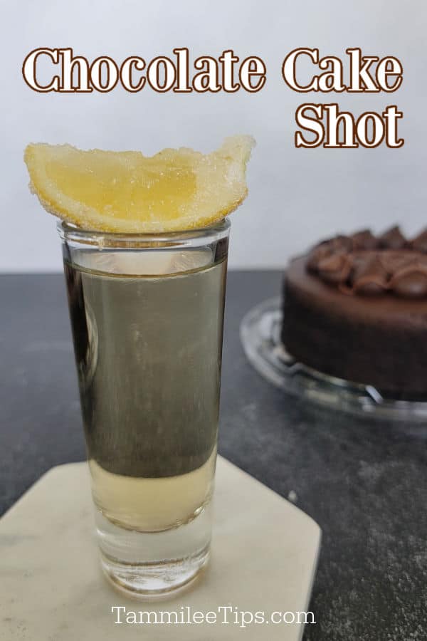 Chocolate Cake Shot text over a shot glass with a lemon wedge and a chocolate cake in the background