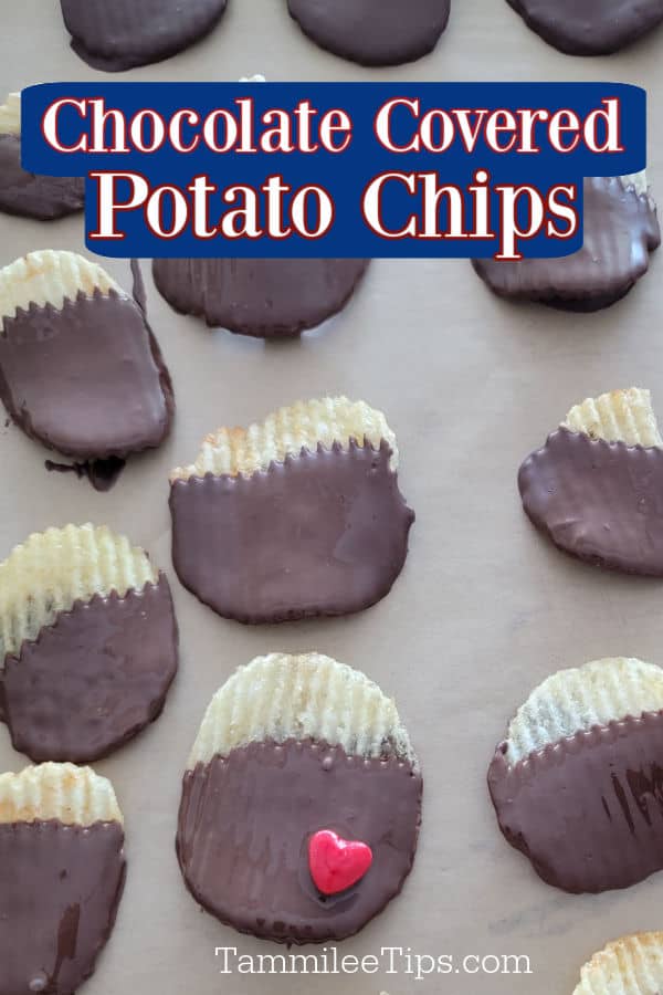Chocolate covered potato chips on parchment paper with one chip having a red heart candy