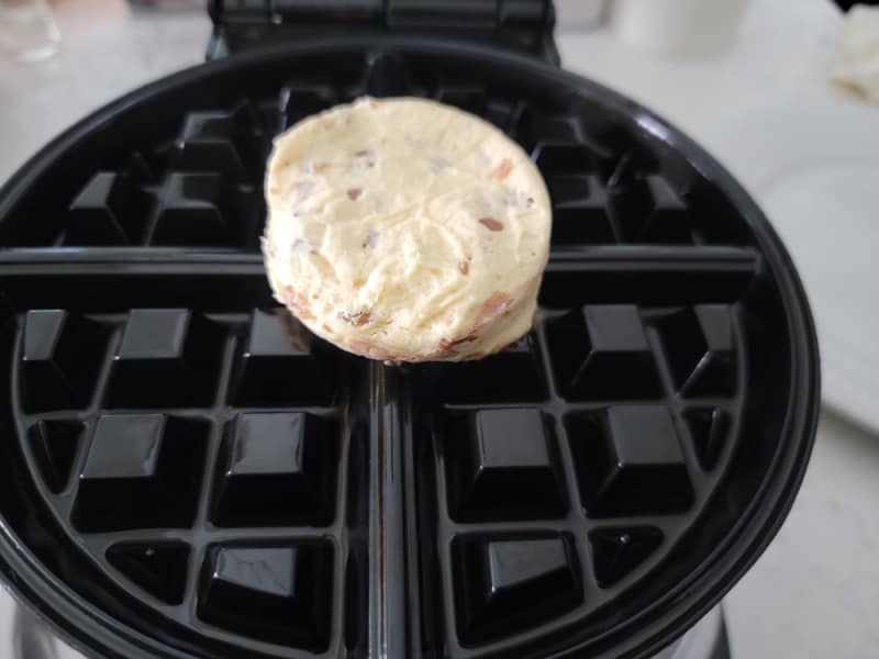 cinnamon roll on a waffle maker before baking