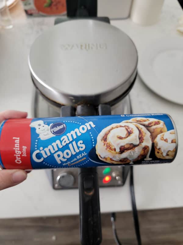 Pillsbury Cinnamon Rolls container in front of a waffle maker