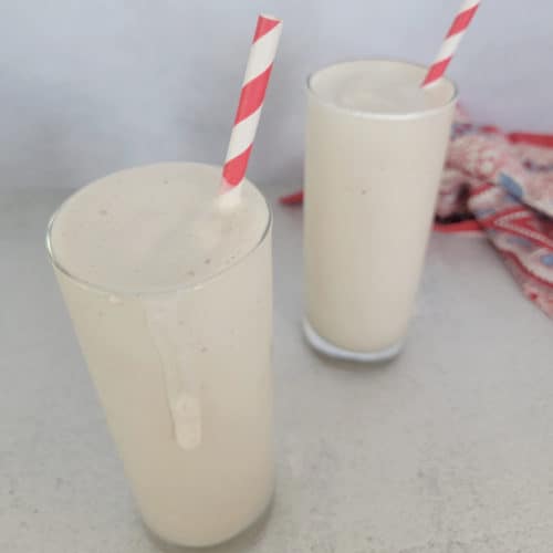 Copycat Chick fil A Frosted Coffee Recipe in tall glasses with red and white paper straws