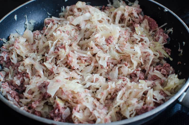 onions and corned beef in a skillet